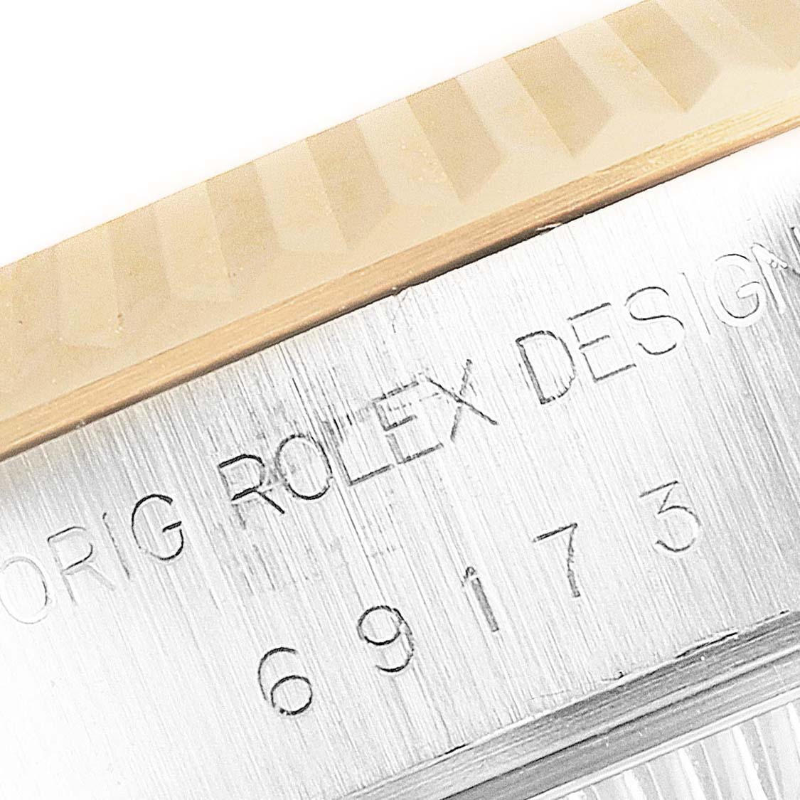 The image shows a close-up of the Rolex logo and model number on the side of a Rolex Datejust 69173 Women
s Steel and Gold (two tone) Champagne Dial 69173 Women
s Steel and Gold (two tone) Champagne Dial watch case and bezel.
