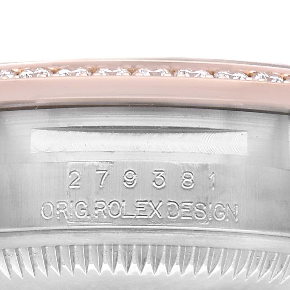 The image shows a close-up of the Rolex Datejust 279381 Women's Steel and Gold (two tone) Brown Dial model's bezel and side with engraved serial details.