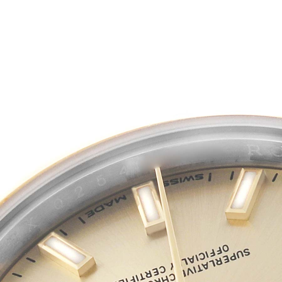 The image shows a close-up of the Rolex Datejust 279163 Women's Steel and Gold (two tone) Champagne Dial watch's dial, including index markers, part of the hands, and text.