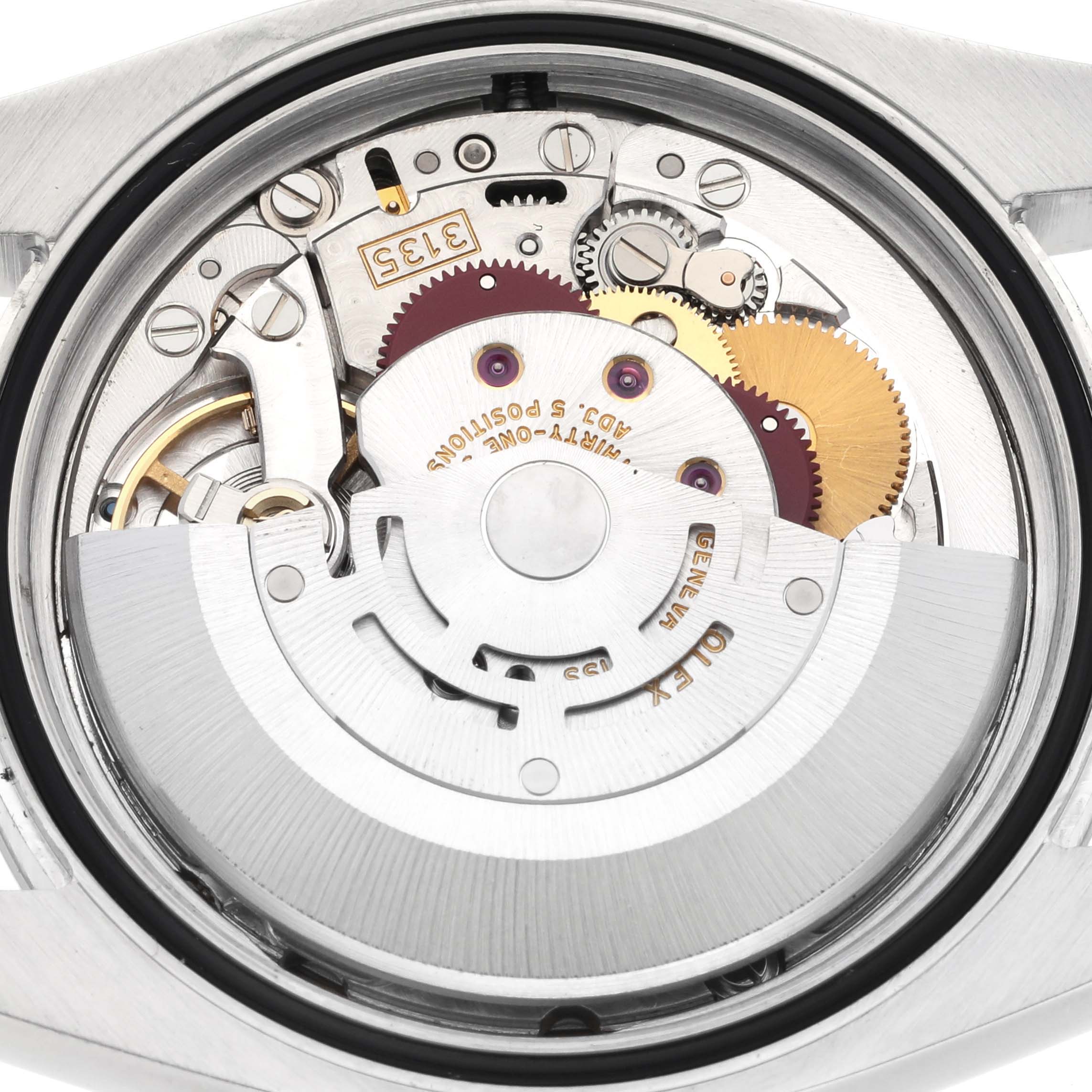 The image shows the Rolex Datejust 116200 Men's Stainless Steel Black Dial 116200 Men's Stainless Steel Black Dial watch movement from a rear angle, highlighting its intricate gears and rotor.