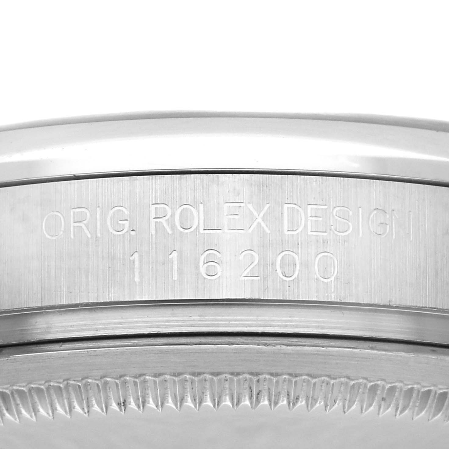 The image shows a close-up side view of the engraved bezel and case edge of a Rolex Datejust 116200 Men's Stainless Steel Black Dial 116200 Men's Stainless Steel Black Dial.