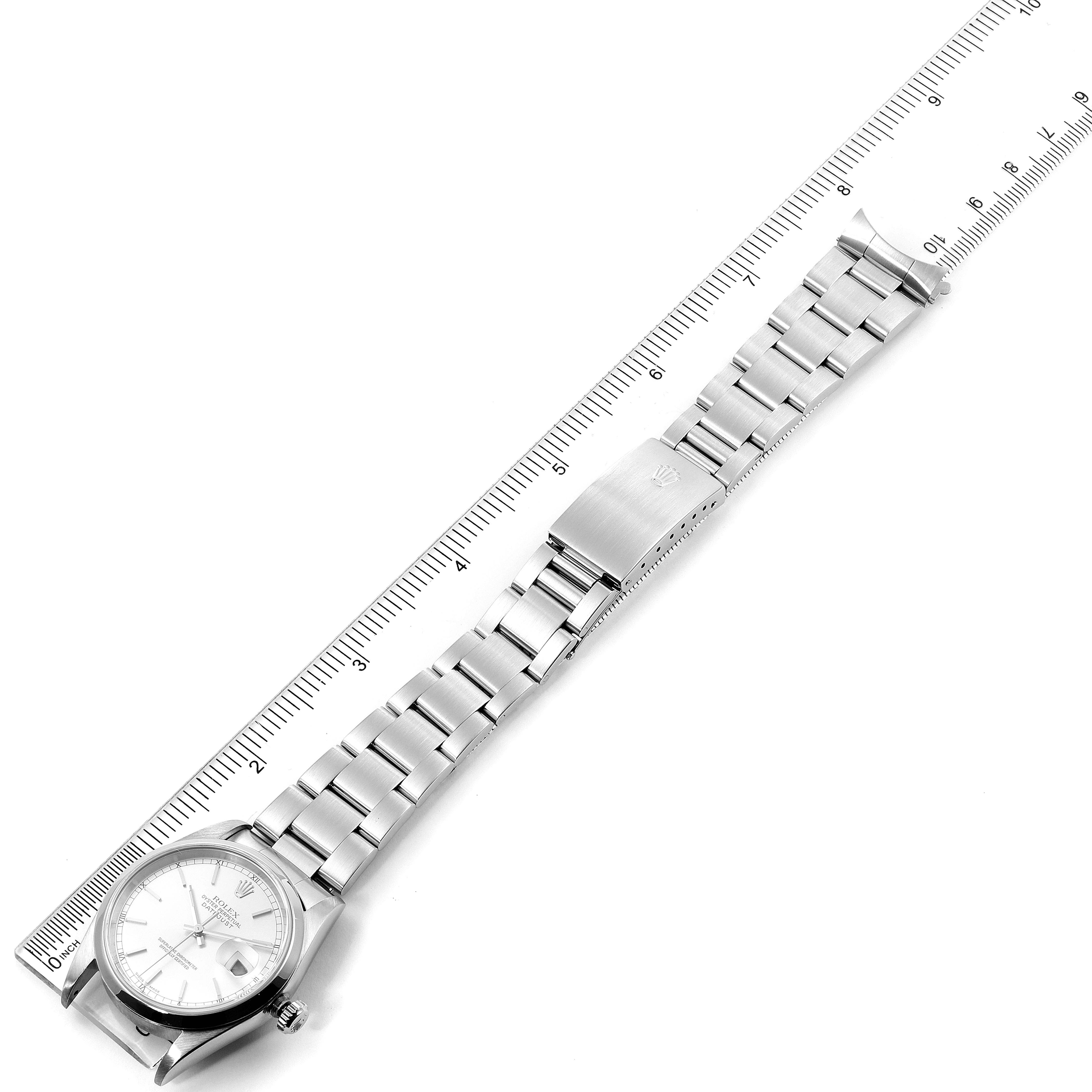 The image shows a top-down view of a Rolex Datejust 16200 Men's Stainless Steel Silver Dial 16200 Men's Stainless Steel Silver Dial watch, highlighting the face, bracelet, and clasp alongside a measuring ruler.
