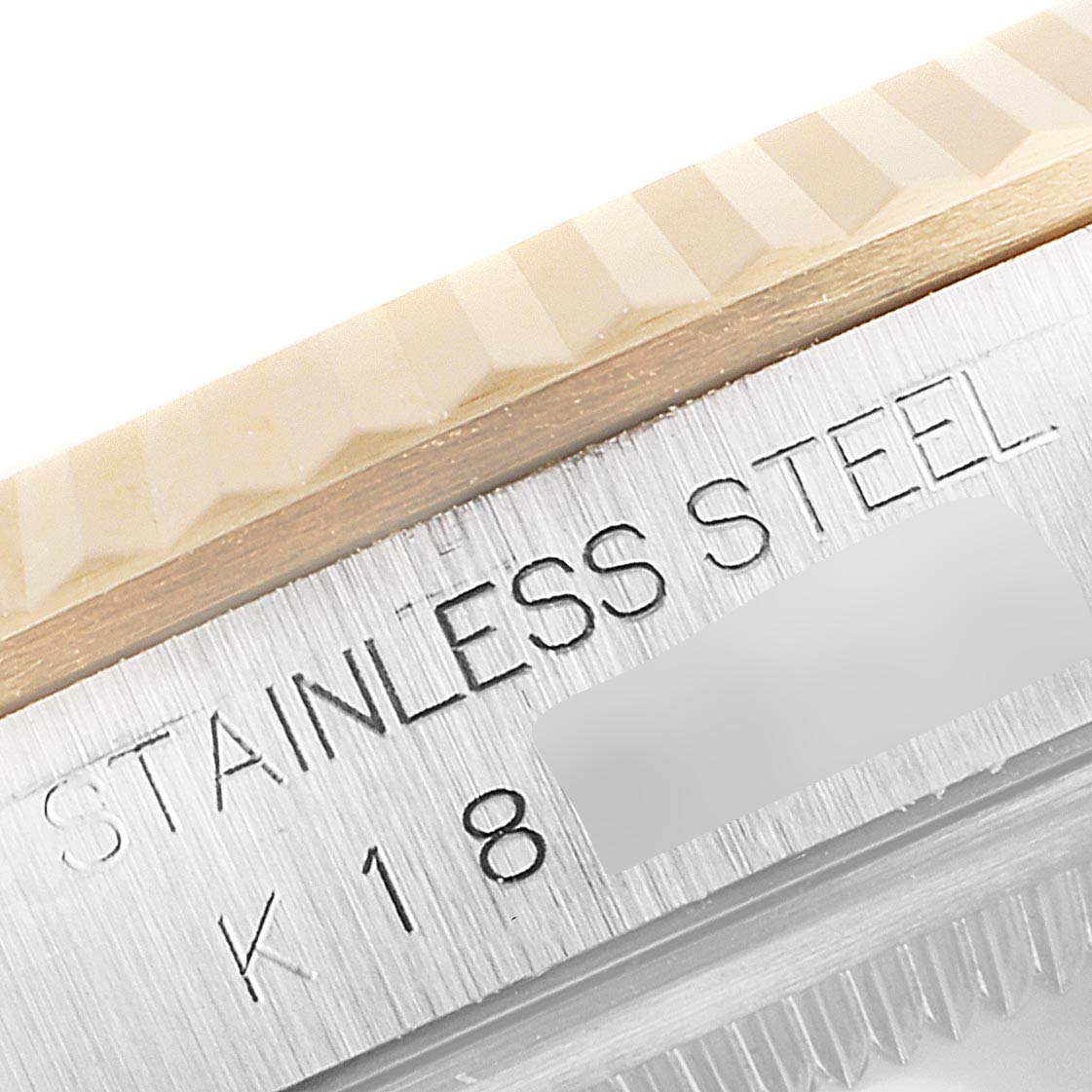 This image shows a close-up of the stainless steel and gold bezel of a Rolex Datejust 16233 Men's Steel and Gold (two tone) Champagne Dial 16233 Men's Steel and Gold (two tone) Champagne Dial watch.