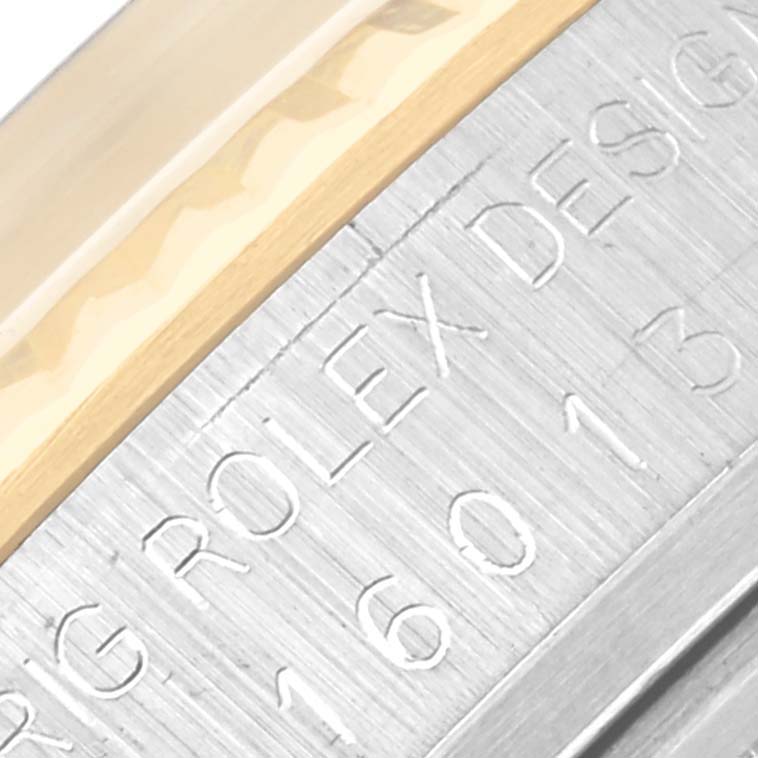 The image shows a close-up angle of the Rolex Datejust 16013 Men's Steel and Gold (two tone) Champagne Dial 16013 Men's Steel and Gold (two tone) Champagne Dial's case side, highlighting the engraved model number.