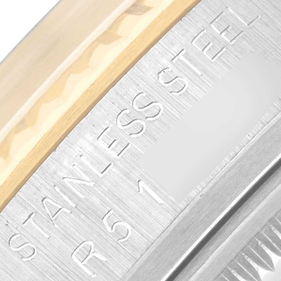 This image shows a close-up angle of the watch edge, highlighting the stainless steel engraving on the Rolex Datejust 16013 Men's Steel and Gold (two tone) Champagne Dial 16013 Men's Steel and Gold (two tone) Champagne Dial model.