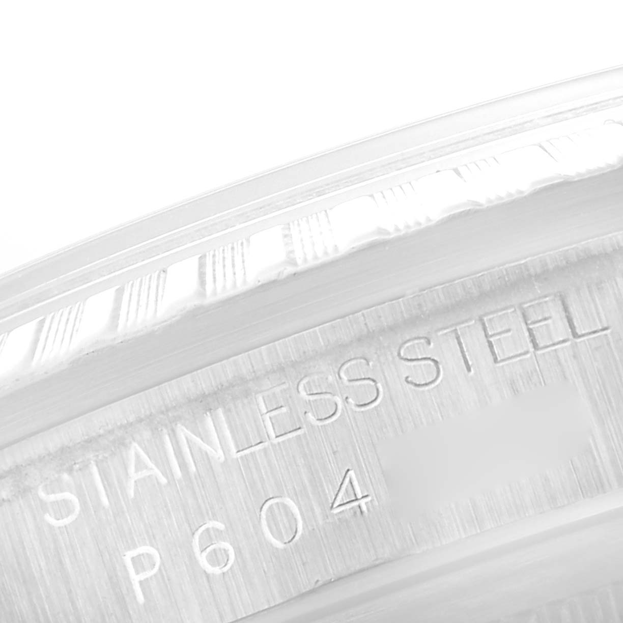 This close-up image shows the stainless steel case and part of the fluted bezel of a Rolex Datejust 16220 Men's Stainless Steel Blue Dial 16220 Men's Stainless Steel Blue Dial watch.