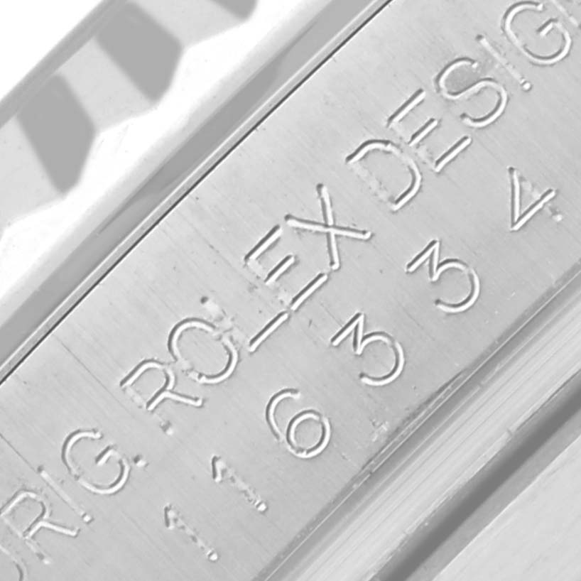 The image shows a close-up of the engraving on the inner bezel of the Rolex Datejust 41 116334 Men's Stainless Steel Blue Dial 116334 Men's Stainless Steel Blue Dial.