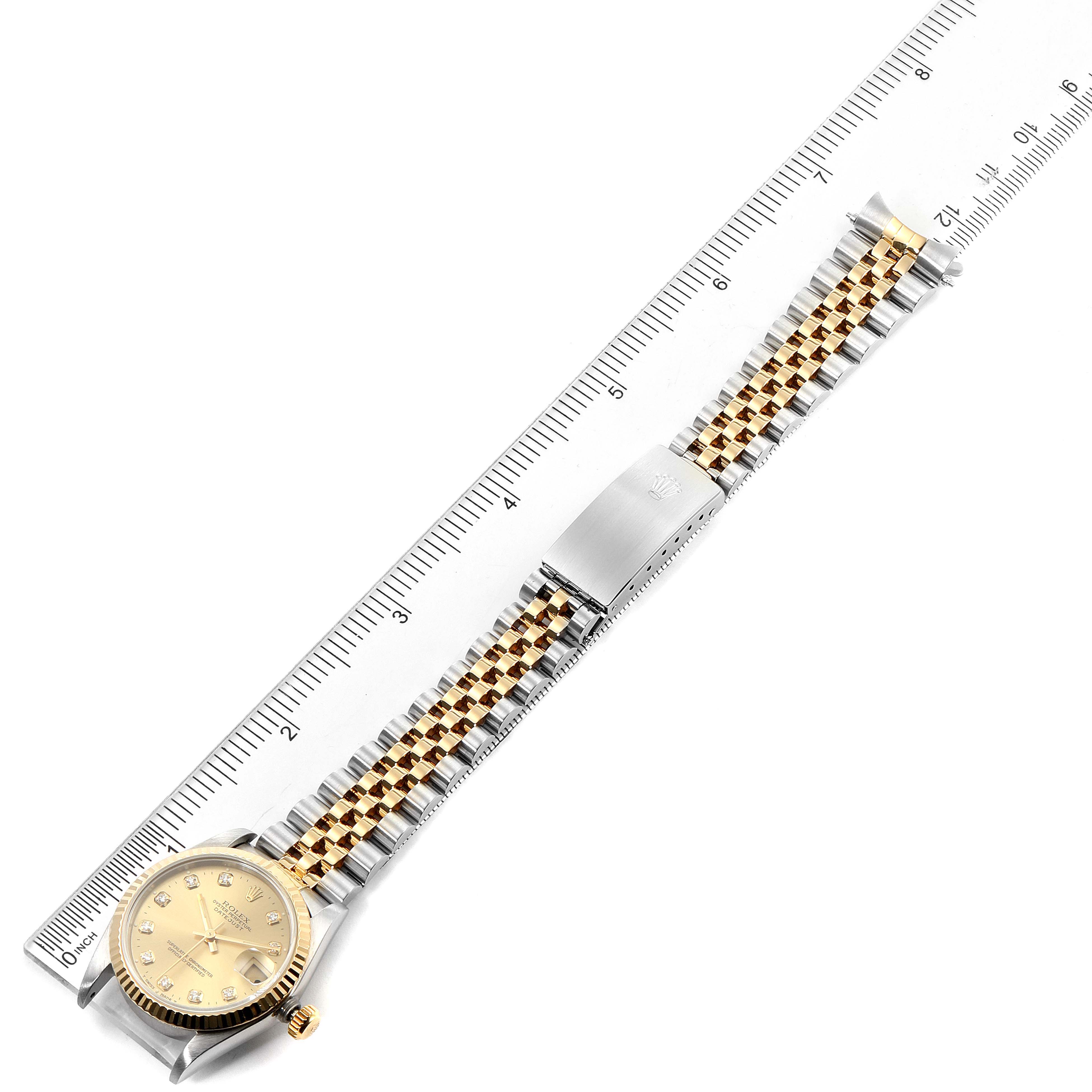 The image shows a top-down view of a Rolex Mid-Size 68273 Women's Steel and Gold (two tone) Champagne Dial 68273 Women's Steel and Gold (two tone) Champagne Dial watch, displaying the face, bezel, and two-tone bracelet with a clasp.