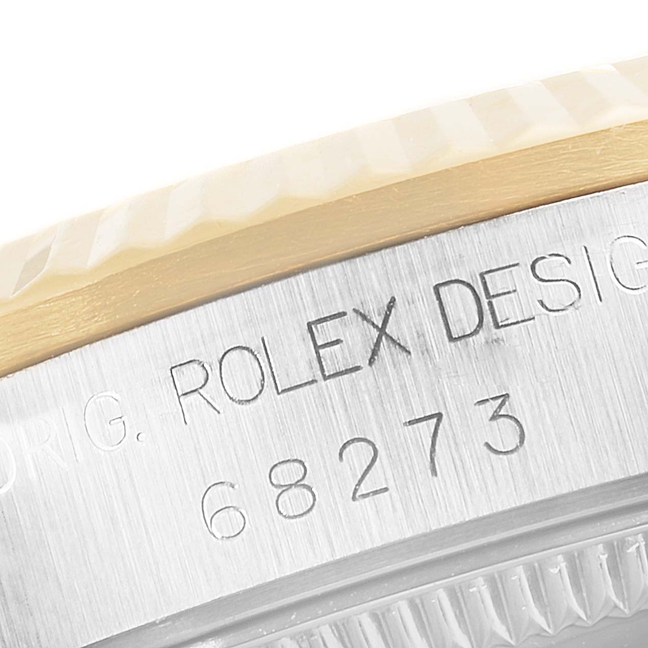 The close-up image shows the side of a Rolex Mid-Size 68273 Women's Steel and Gold (two tone) Champagne Dial 68273 Women's Steel and Gold (two tone) Champagne Dial watch, focusing on the engraved model number and part of the bezel.