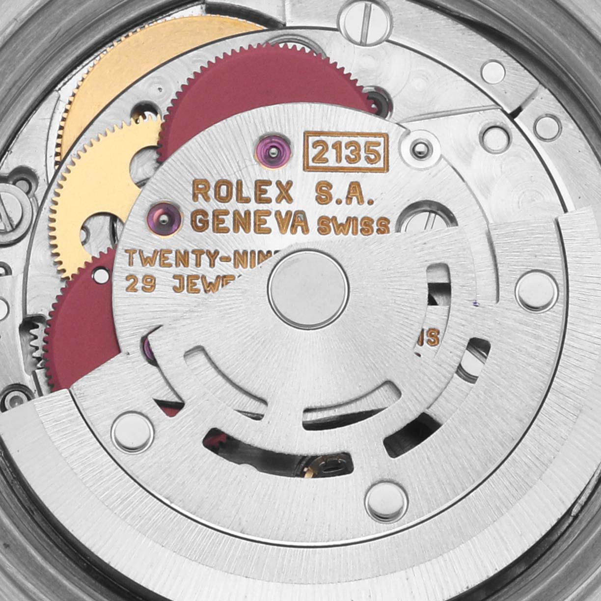 The image shows a close-up of the Rolex Datejust 69173 Women's Steel and Gold (two tone) White Dial 69173 Women's Steel and Gold (two tone) White Dial movement, highlighting gears, text, and mechanical components from above.