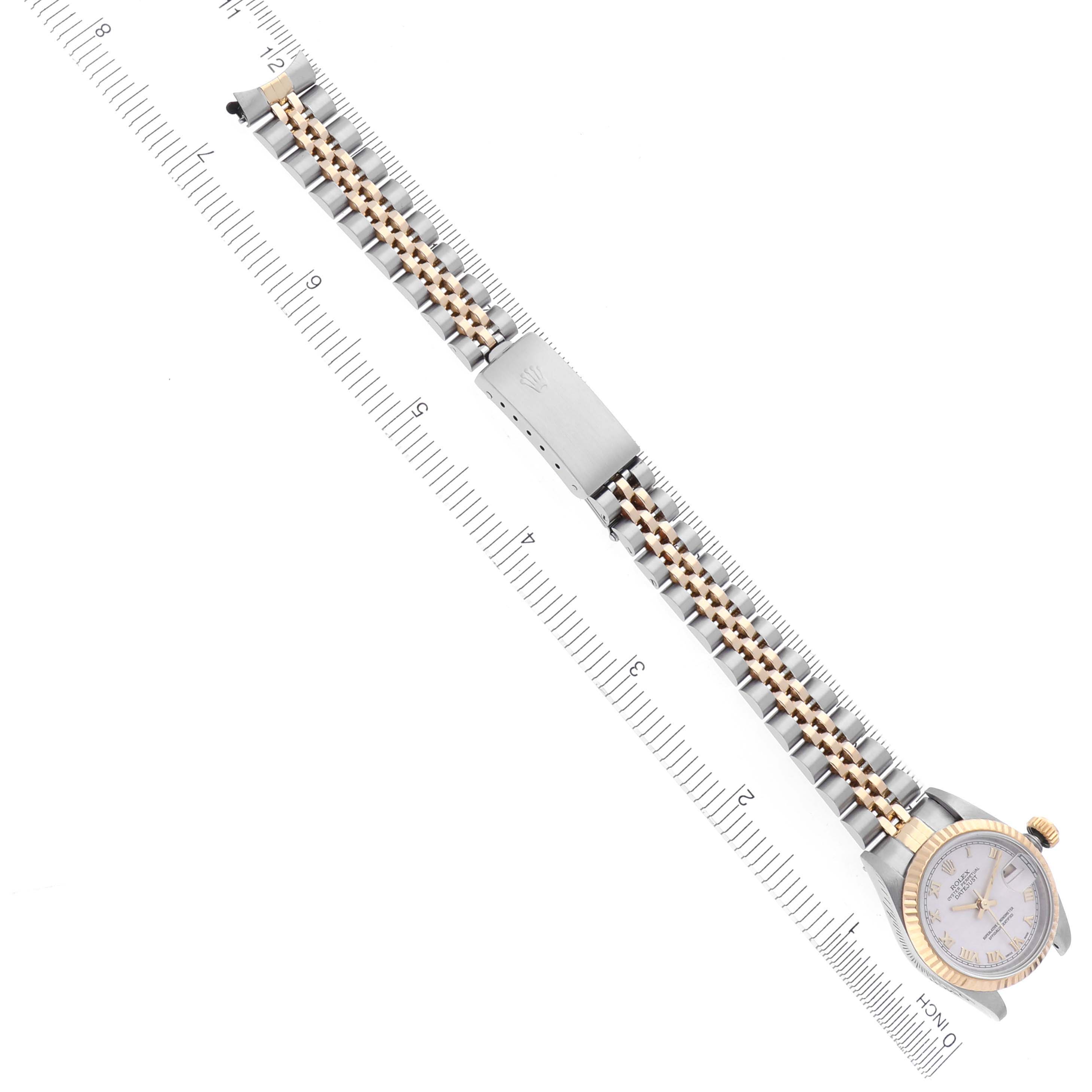 The image shows a Rolex Datejust 69173 Women's Steel and Gold (two tone) White Dial 69173 Women's Steel and Gold (two tone) White Dial watch from a top view, highlighting the bracelet, clasp, and partial dial with a measuring ruler.