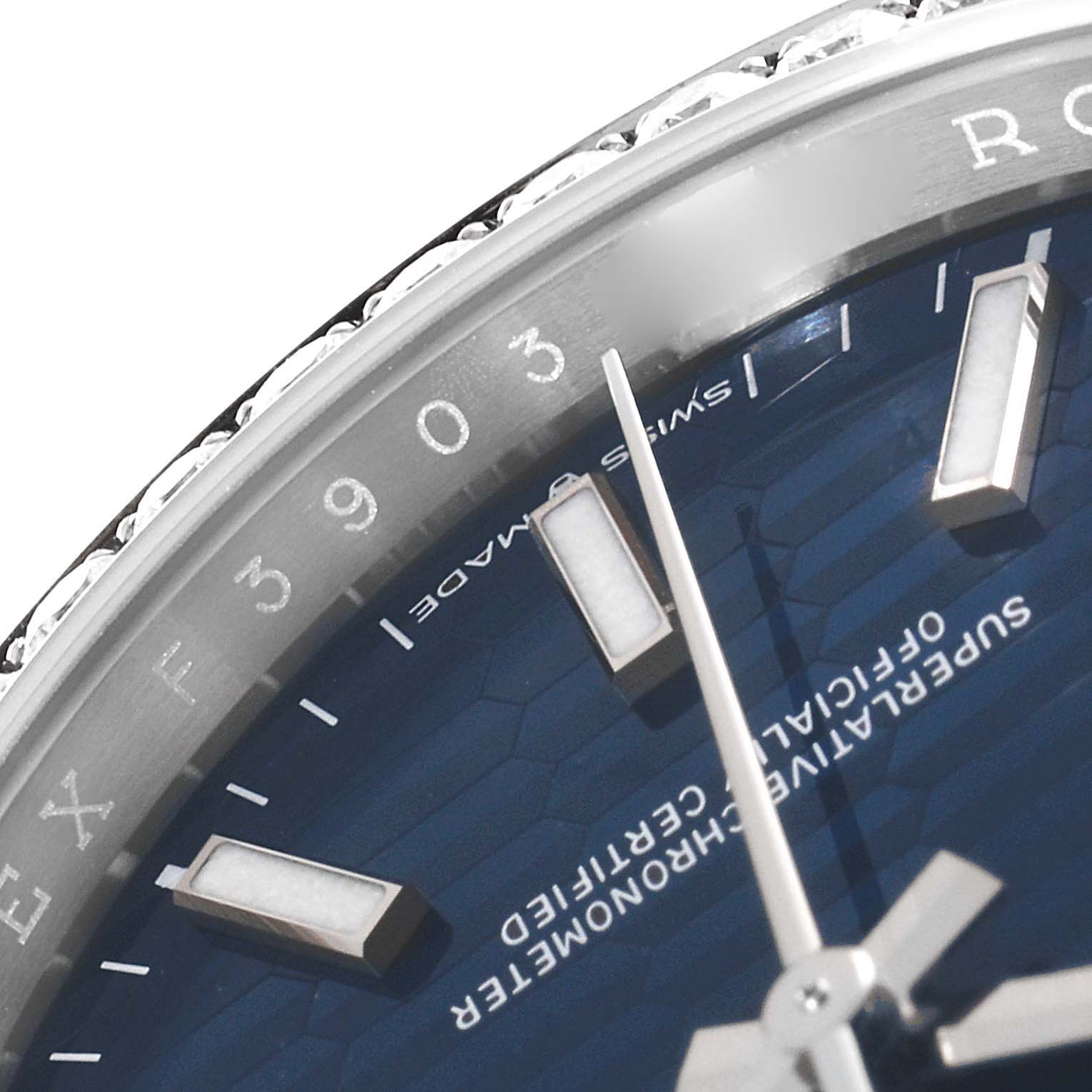 This close-up of a Rolex Datejust 126284 Men's Stainless Steel Blue Dial 126284 Men's Stainless Steel Blue Dial watch shows part of the dial and bezel, focusing on the markers and part of the hands.