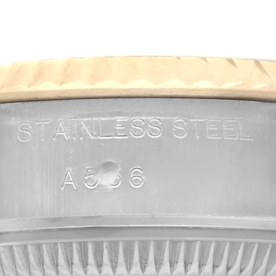 The image shows a side angle of the Rolex Datejust 79173 Women's Steel and Gold (two tone) Champagne Dial 79173 Women's Steel and Gold (two tone) Champagne Dial, highlighting the stainless steel case with engraved text.