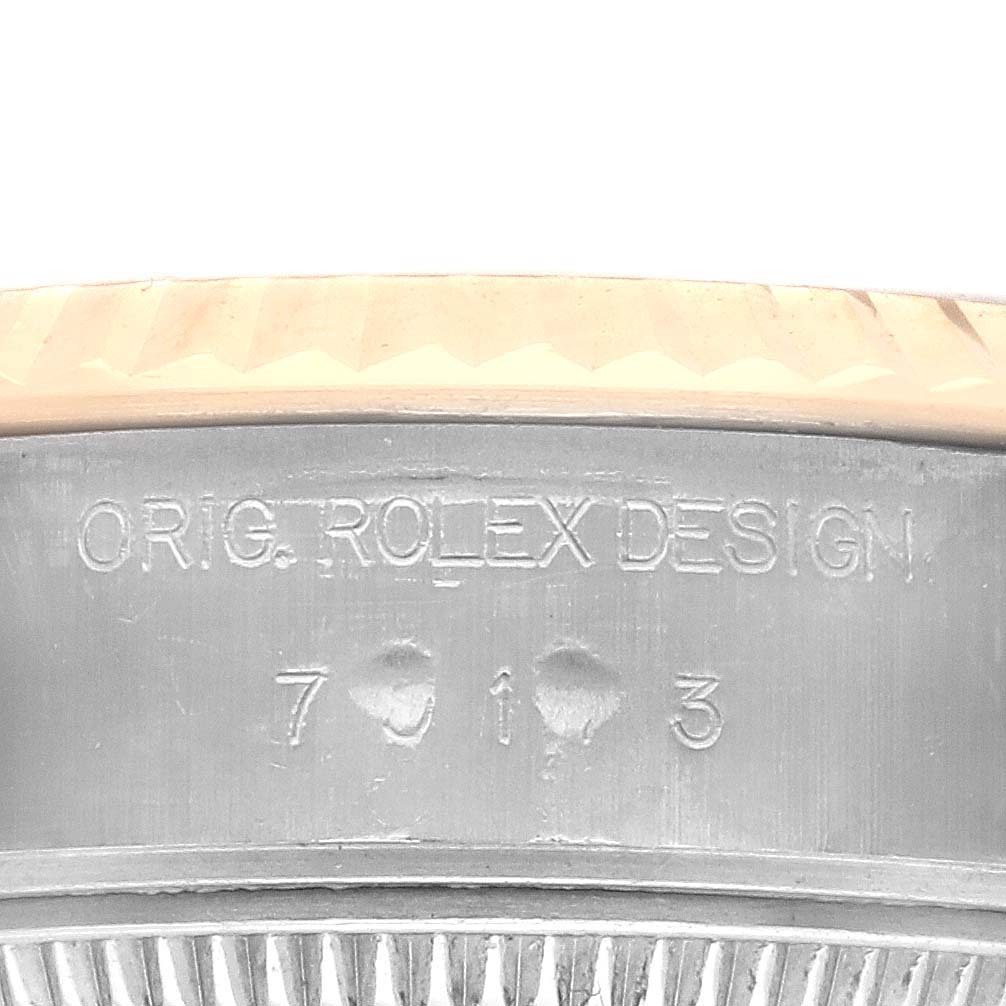 This image shows the side engraving on the bezel of a Rolex Datejust 79173 Women's Steel and Gold (two tone) Champagne Dial 79173 Women's Steel and Gold (two tone) Champagne Dial watch.