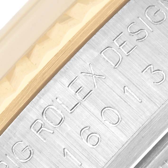 The image shows a close-up of the Rolex Datejust 16013 Men's Steel and Gold (two tone) Champagne Dial 16013 Men's Steel and Gold (two tone) Champagne Dial model's side, focusing on the engraved design details.