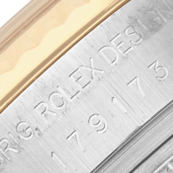The image shows a close-up of the bezel and edge of the case, highlighting the engraving on a Rolex Datejust 179173 Women's Steel and Gold (two tone) Mother of Pearl Dial 179173 Women's Steel and Gold (two tone) Mother of Pearl Dial.