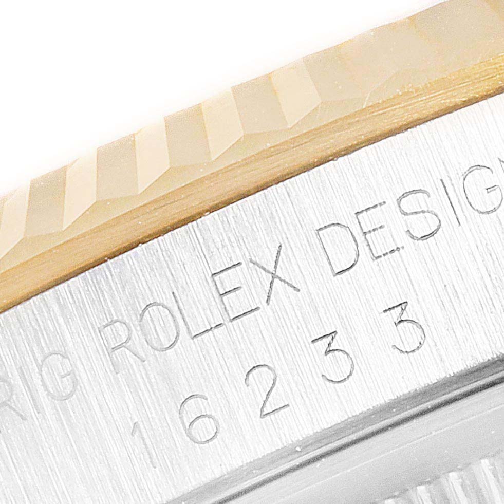 The image shows a close-up of the bezel and engraved model details of a Rolex Datejust 16233 Men's Steel and Gold (two tone) White Dial 16233 Men's Steel and Gold (two tone) White Dial watch.