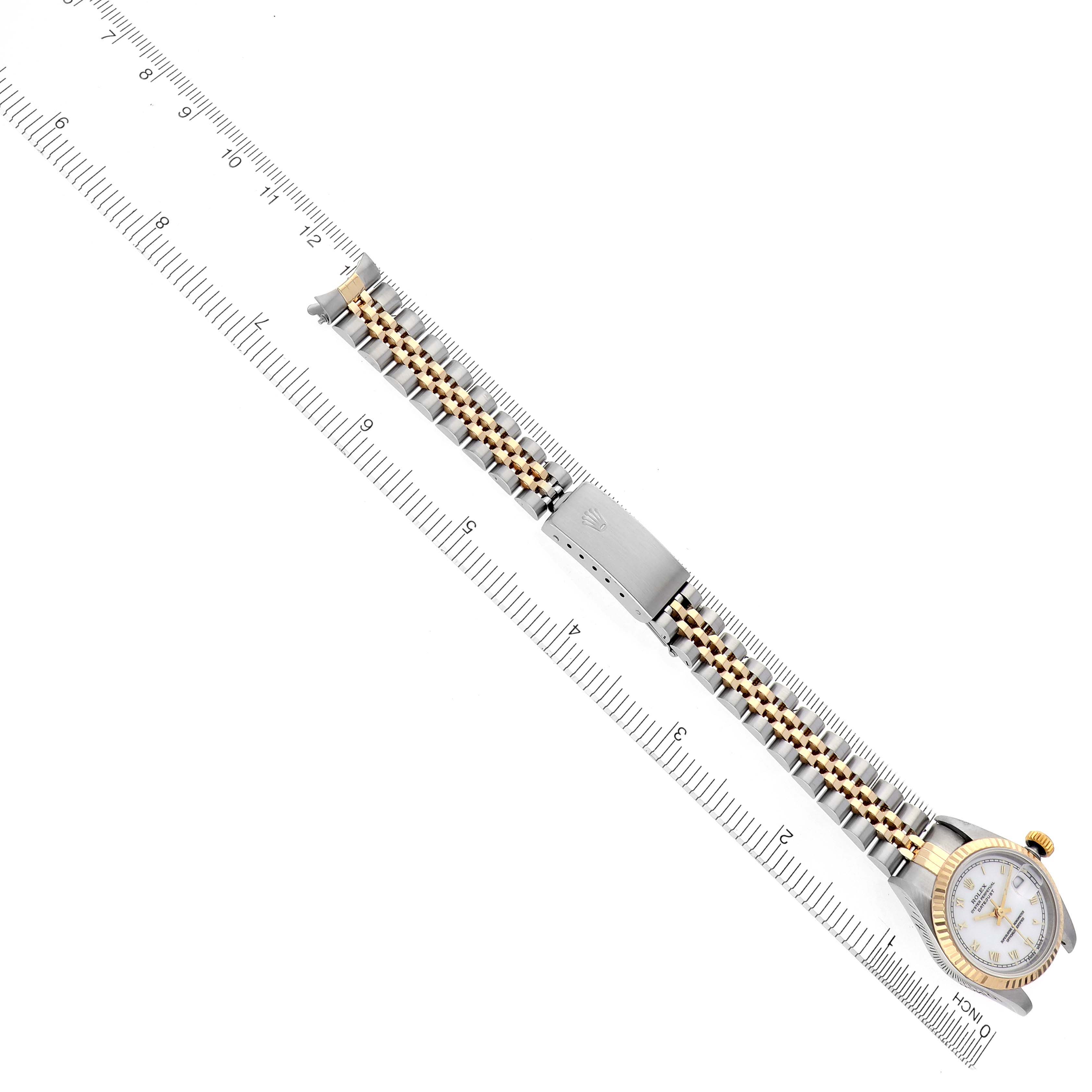 The Rolex Datejust 69173 Women's Steel and Gold (two tone) White Dial 69173 Women's Steel and Gold (two tone) White Dial watch is shown from a top view, highlighting the bracelet, clasp, and dial next to a ruler.