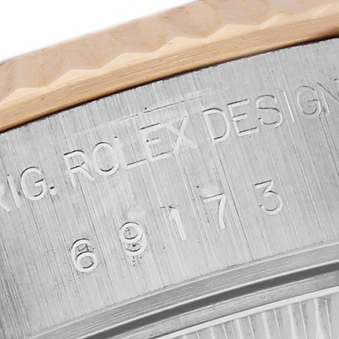 The image shows a close-up of the side edge with engravings on the Rolex Datejust 69173 Women's Steel and Gold (two tone) White Dial 69173 Women's Steel and Gold (two tone) White Dial's case.
