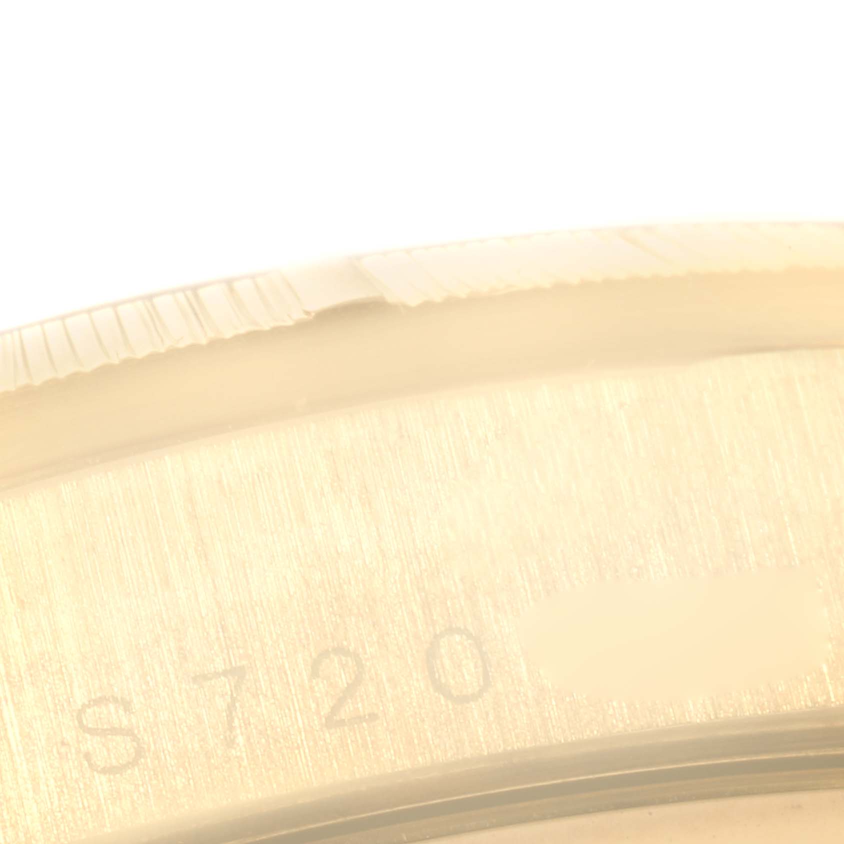 This image shows a close-up angle of the serial number engraving on the case of a Rolex President 18248 Men's Yellow Gold Champagne Dial 18248 Men's Yellow Gold Champagne Dial model watch.
