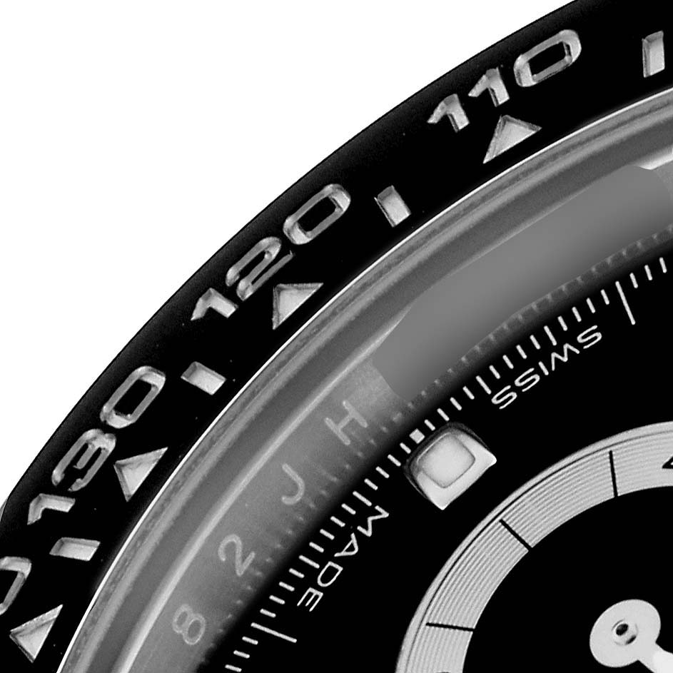 The image shows a close-up of the bezel and part of the dial of the Rolex Daytona 116500LN Men's Stainless Steel Black Dial 116500LN Men's Stainless Steel Black Dial watch.