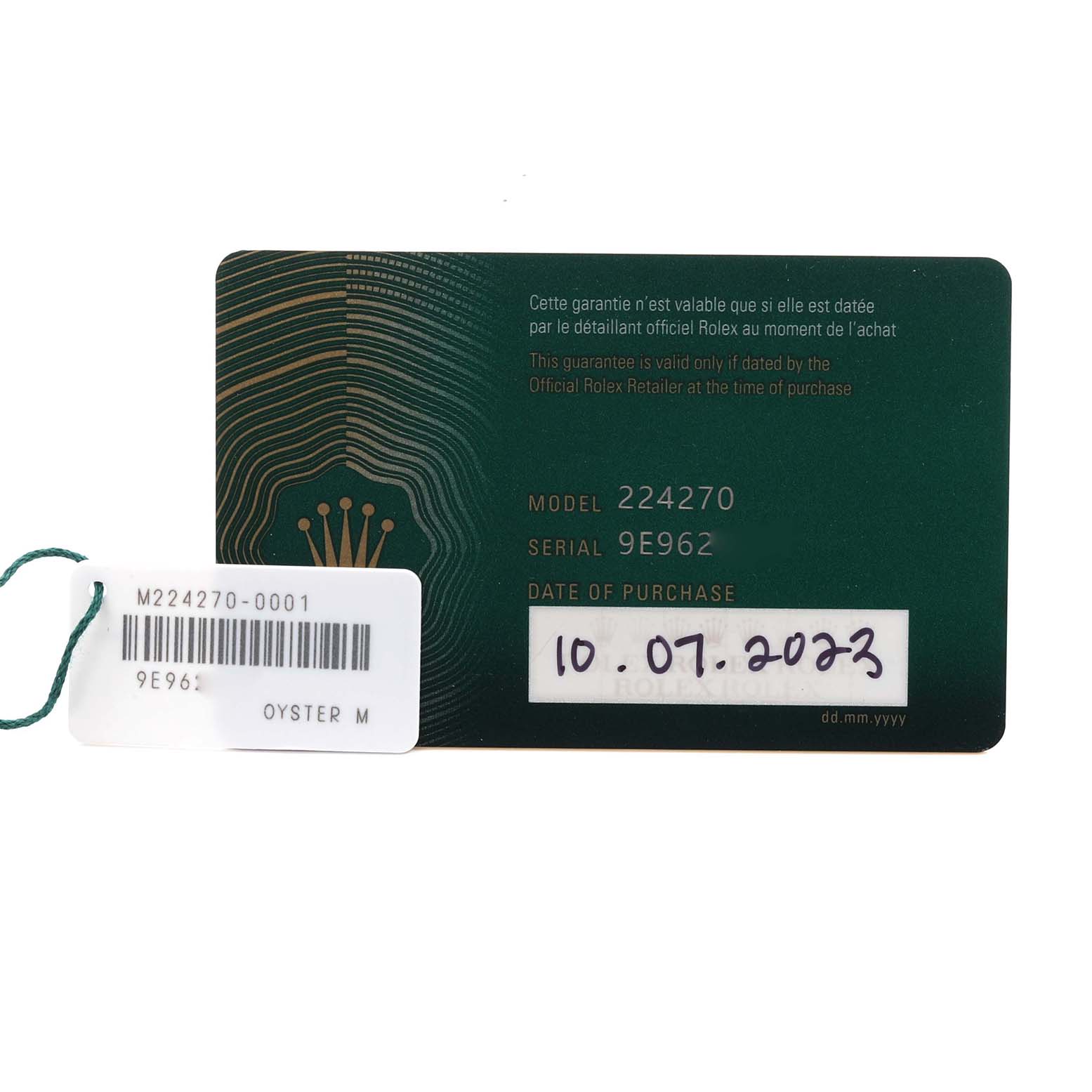 The image shows a close-up of the Rolex Explorer 224270 Men
s Stainless Steel Black Dial 224270 Men
s Stainless Steel Black Dial model 224270 warranty card and a tag with serial information.