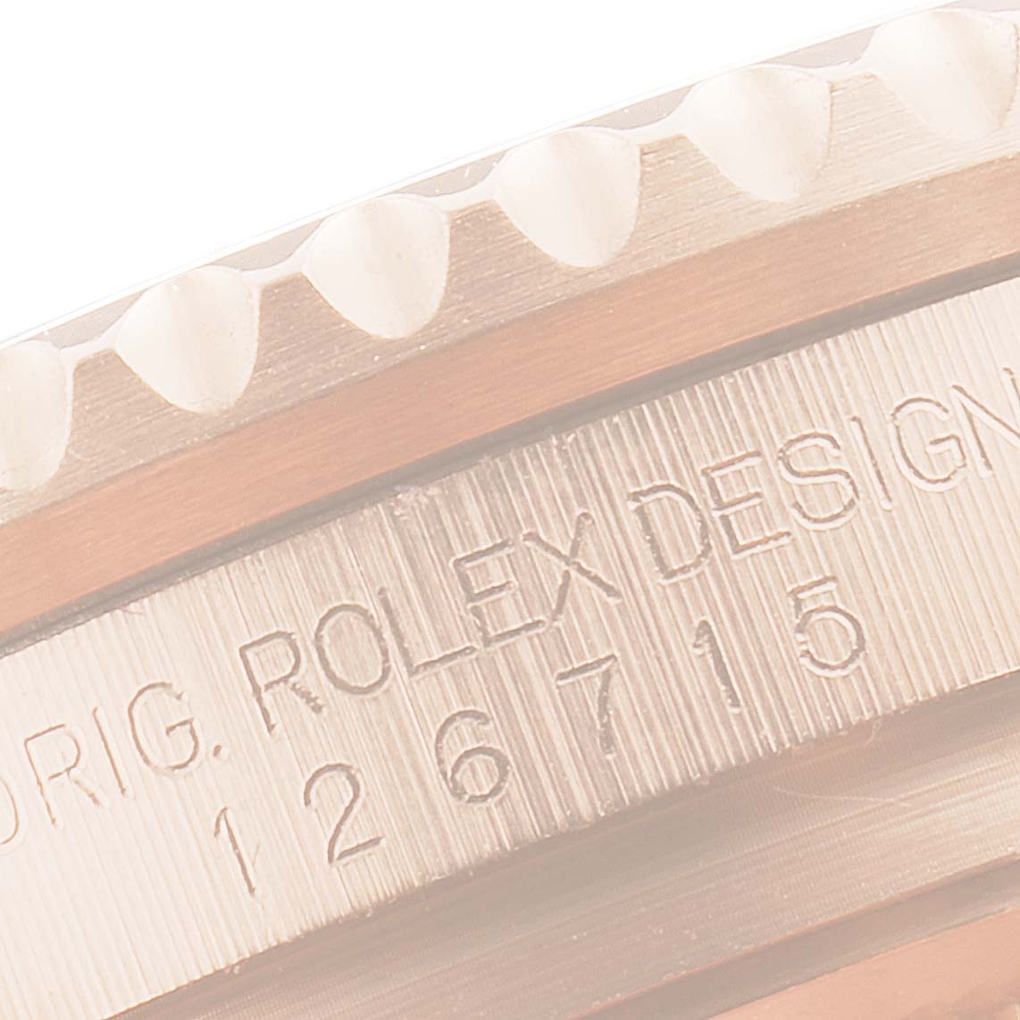 This image shows a close-up of the engraved model number and bezel of a Rolex GMT-Master 126715 Men's Rose Gold Black Dial 126715 Men's Rose Gold Black Dial watch.
