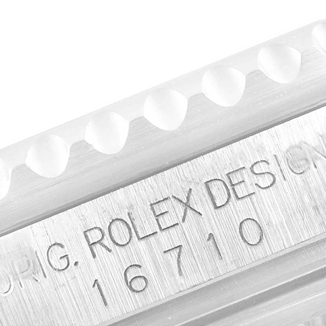 This close-up image shows the case side and serial number engraving on the bezel of a Rolex GMT-Master 16710 Men
s Stainless Steel Black Dial 16710 Men
s Stainless Steel Black Dial model 16710.