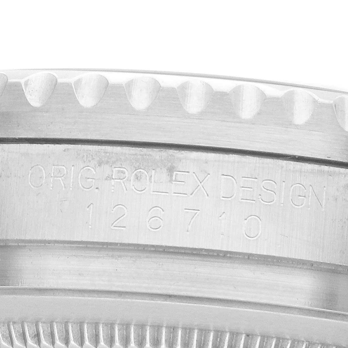 The image shows a close-up of the case edge with the model number engraving on the Rolex GMT-Master 126710 Men's Stainless Steel Black Dial.
