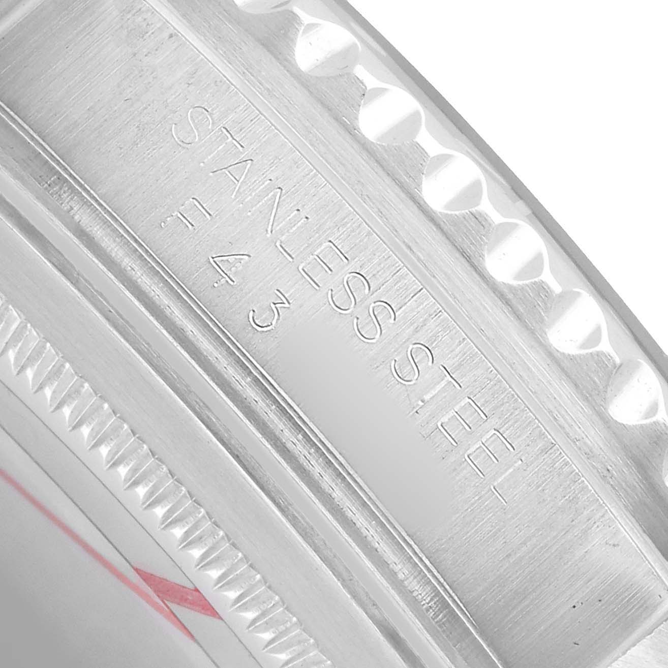 The image shows a close-up of the side of the Rolex GMT-Master 16710 Men's Stainless Steel Black Dial's stainless steel case with engraved markings.