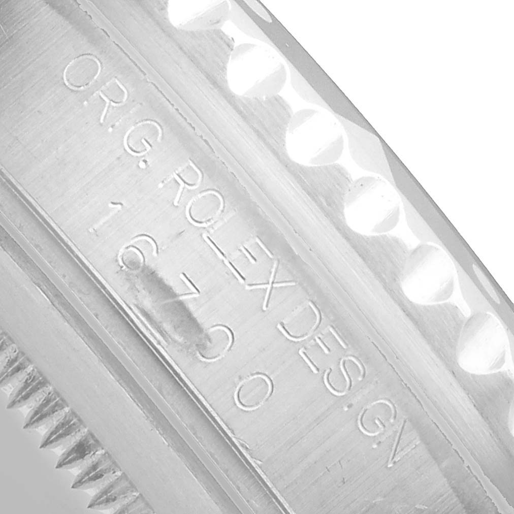 The image shows a close-up of the engraved inner bezel of a Rolex GMT-Master 16700 Men's Stainless Steel Black Dial, displaying "ORIG. ROLEX DESIGN" and the model number.