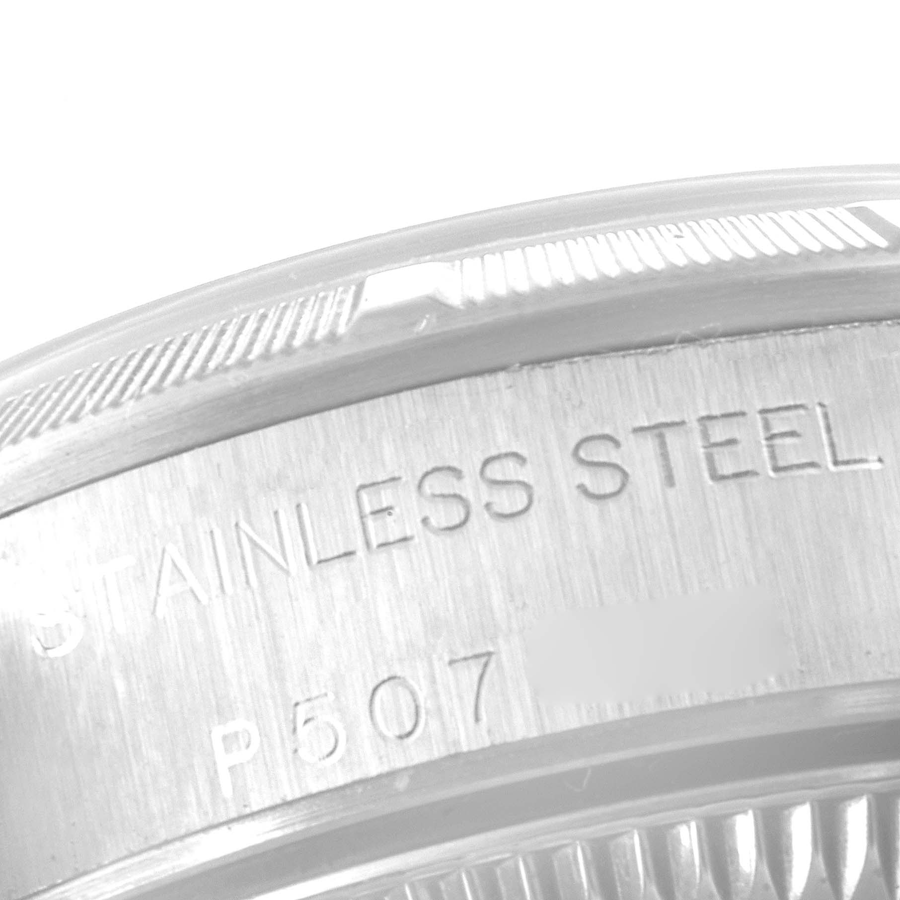 This close-up image of the Rolex Oyster Perpetual 76030 Women's Stainless Steel White Dial 76030 Women's Stainless Steel White Dial watch focuses on the stainless steel case back and an engraved model number.