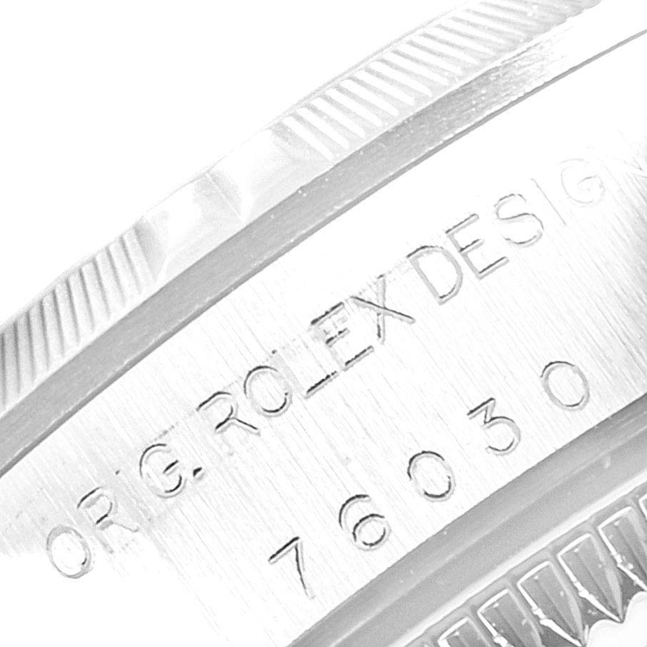 This image shows a close-up of the engraved side and part of the bezel of a Rolex Oyster Perpetual 76030 Women's Stainless Steel White Dial 76030 Women's Stainless Steel White Dial watch.