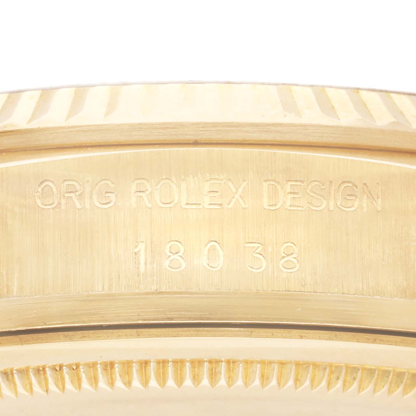 The image shows the side view of the Rolex President 18038 Men
s Yellow Gold Champagne Dial 18038 Men
s Yellow Gold Champagne Dial model, focusing on the engravings and fluted bezel.