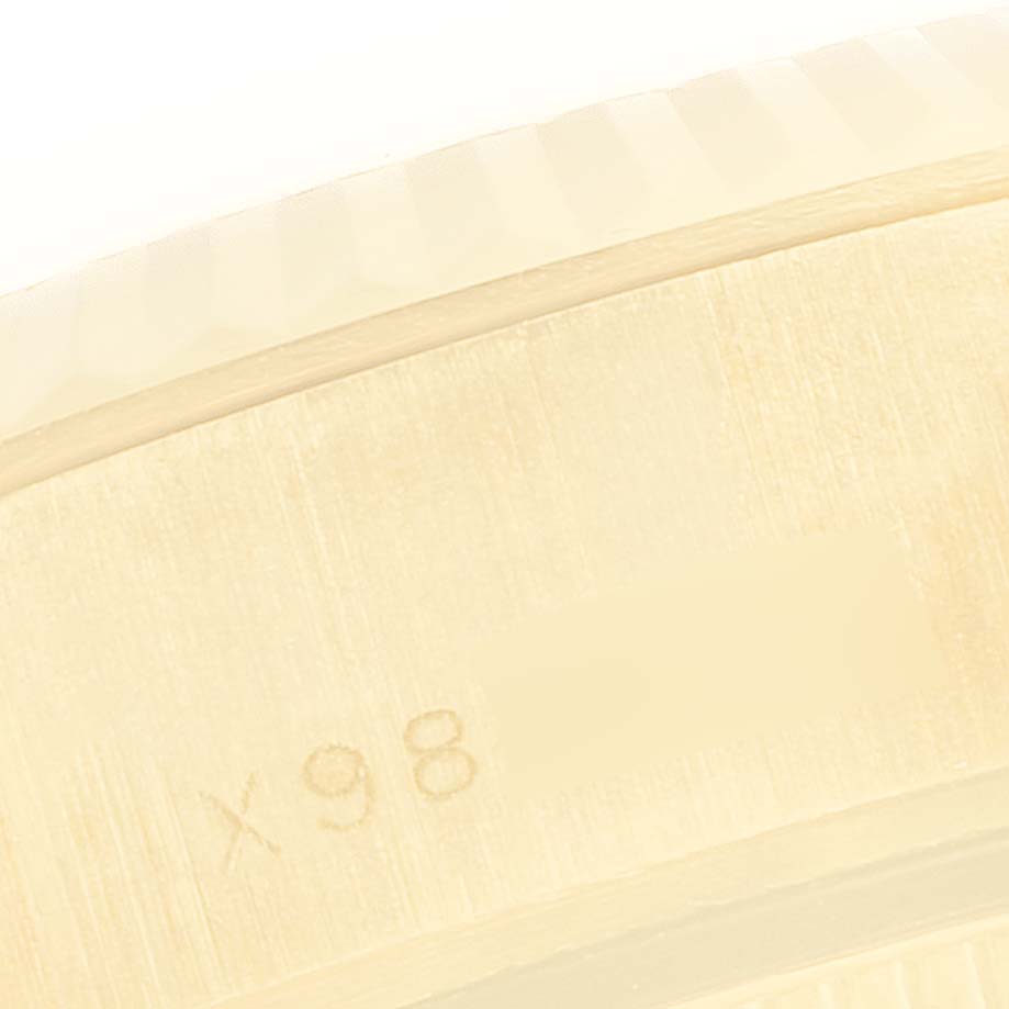 The image shows a close-up of the serial number engraving along the inner bezel of the Rolex President 69178 Women's Yellow Gold Green Dial 69178 Women's Yellow Gold Green Dial model watch.