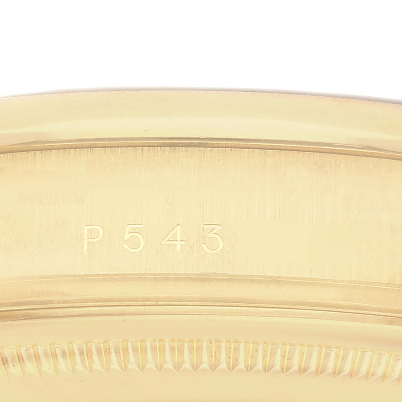 The image shows a close-up of the case side with engraving "P543" on the Rolex President 118208 Men's Yellow Gold White Dial 118208 Men's Yellow Gold White Dial model.