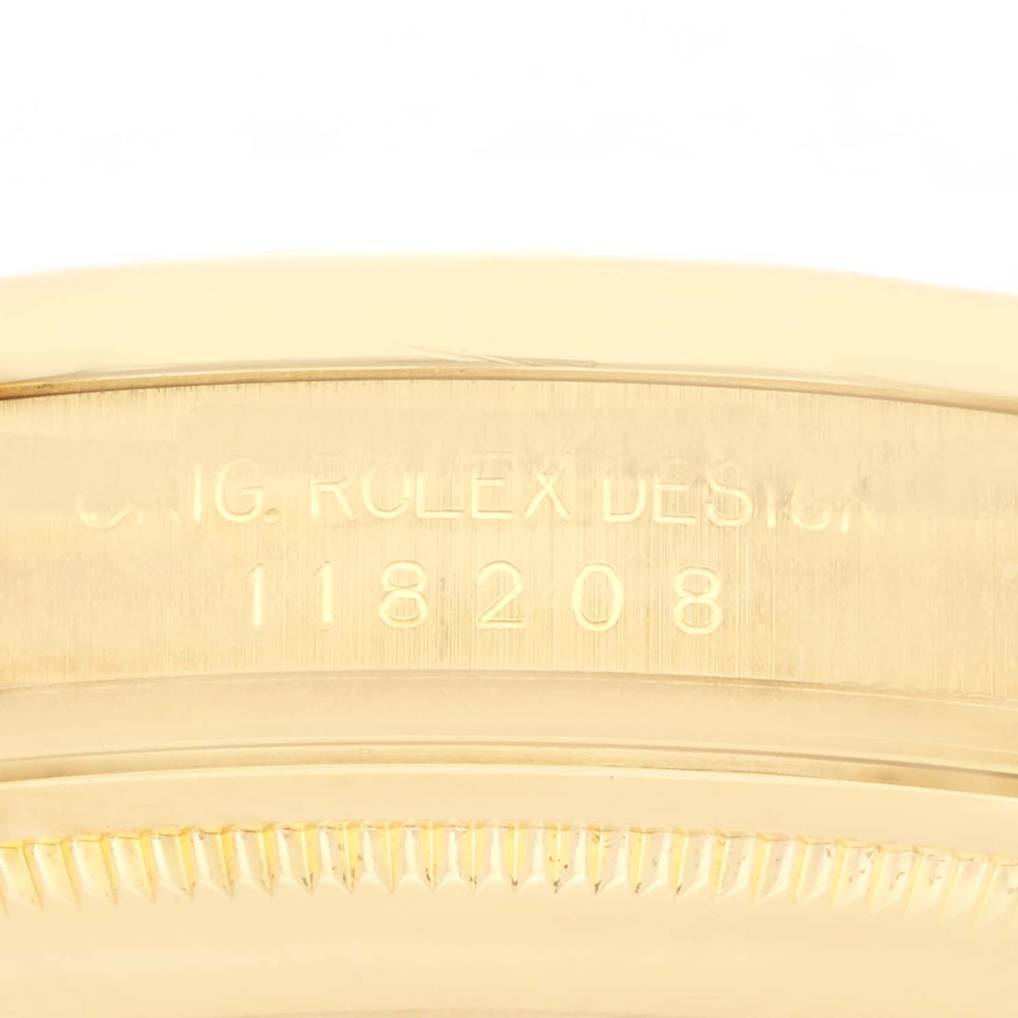 The image shows a close-up of the side of a Rolex President 118208 Men's Yellow Gold White Dial 118208 Men's Yellow Gold White Dial model, highlighting the engraved design number.