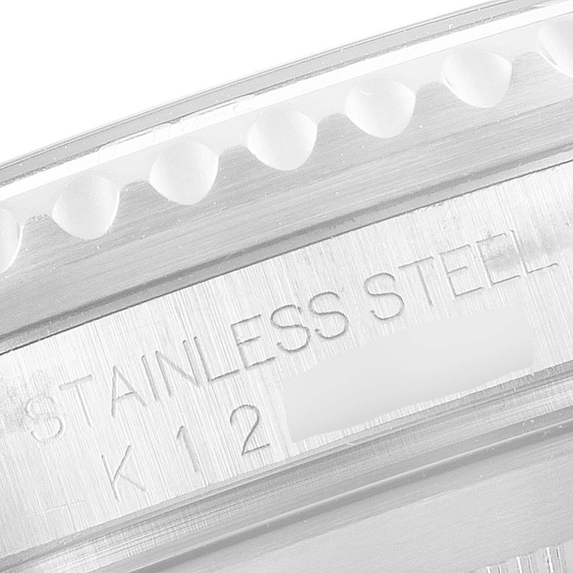 This close-up image shows the bezel and case side of a Rolex Submariner 16610 Men's Stainless Steel Black Dial 16610 Men's Stainless Steel Black Dial watch with "STAINLESS STEEL" engraving.