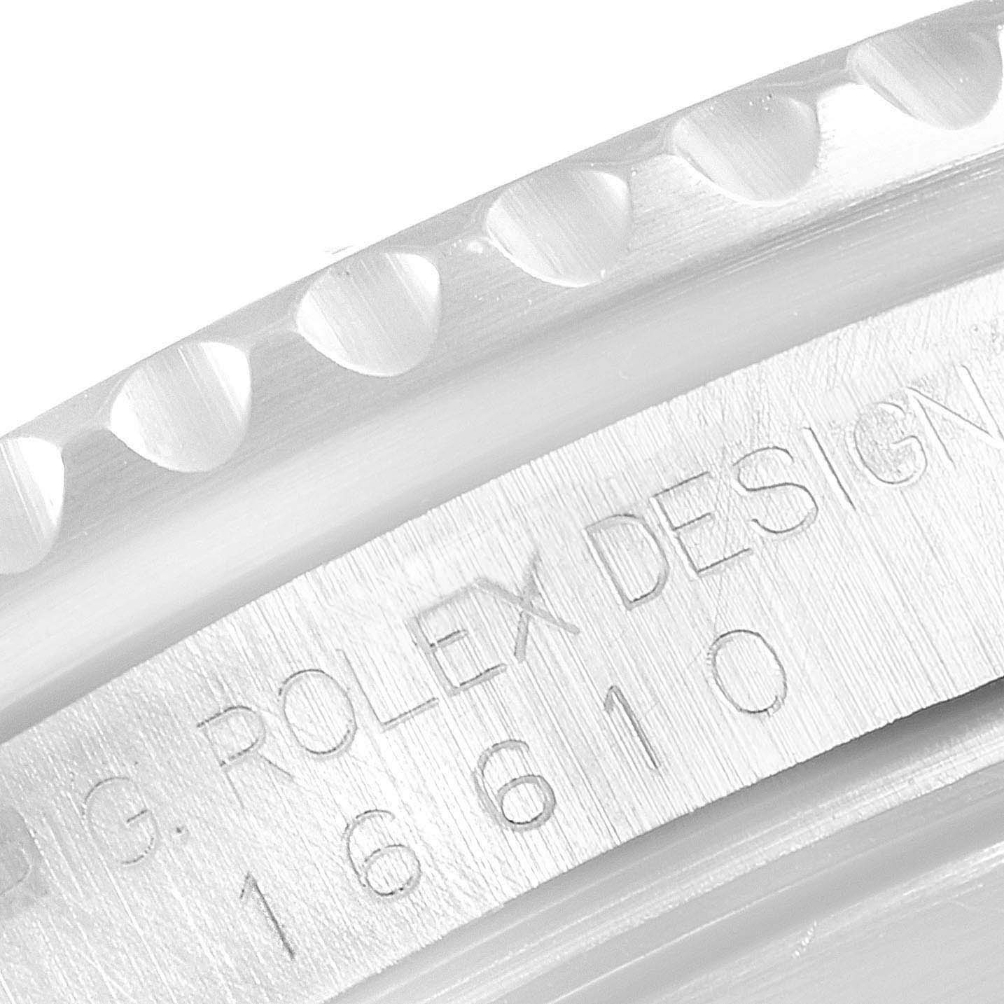 This close-up image shows the engraved serial number on the case side of a Rolex Submariner 16610 Men's Stainless Steel Black Dial 16610 Men's Stainless Steel Black Dial watch.