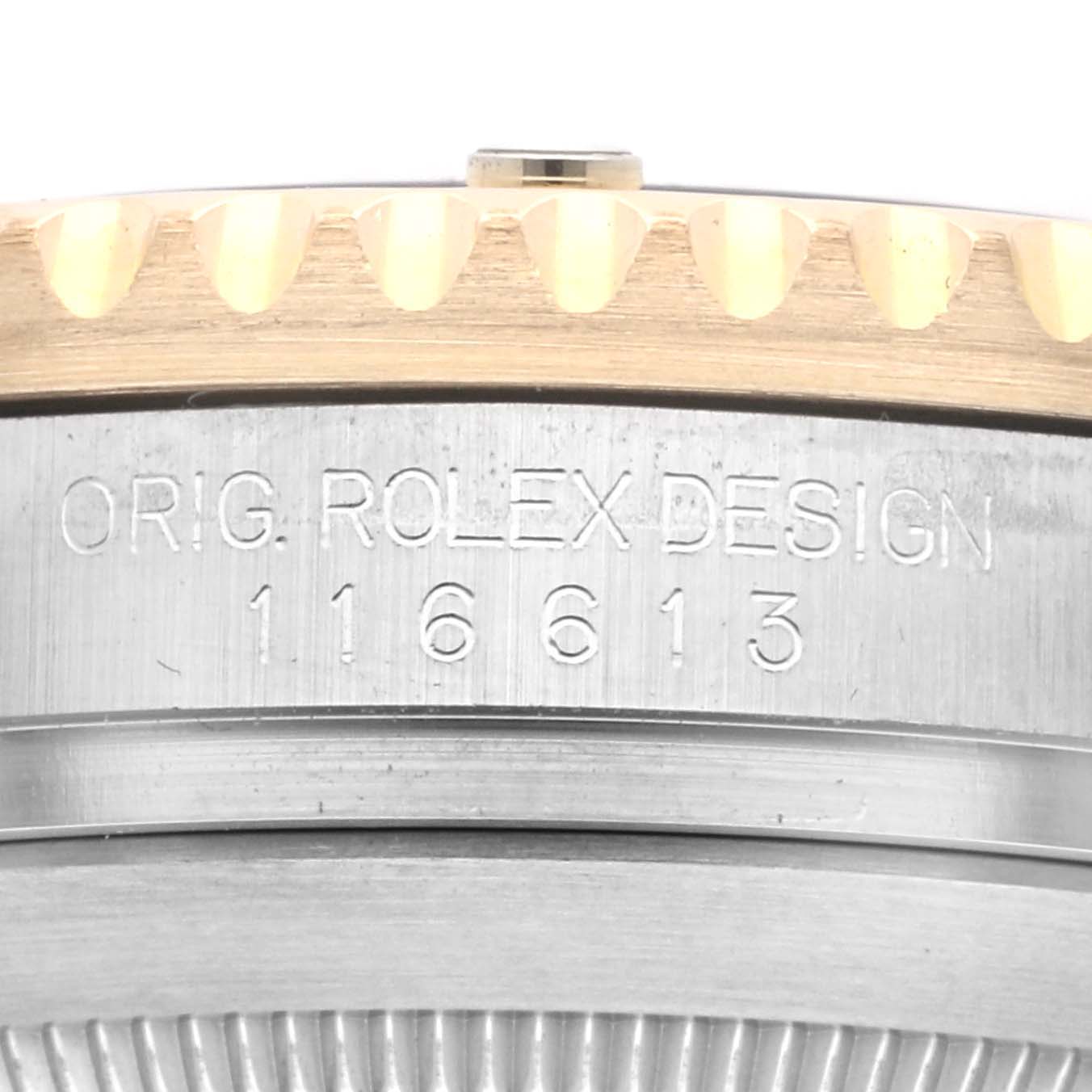 The image shows a close-up of the side engraving on the bezel and case of a Rolex Submariner 116613LN Men's Steel and Gold (two tone) Black Dial 116613LN Men's Steel and Gold (two tone) Black Dial.