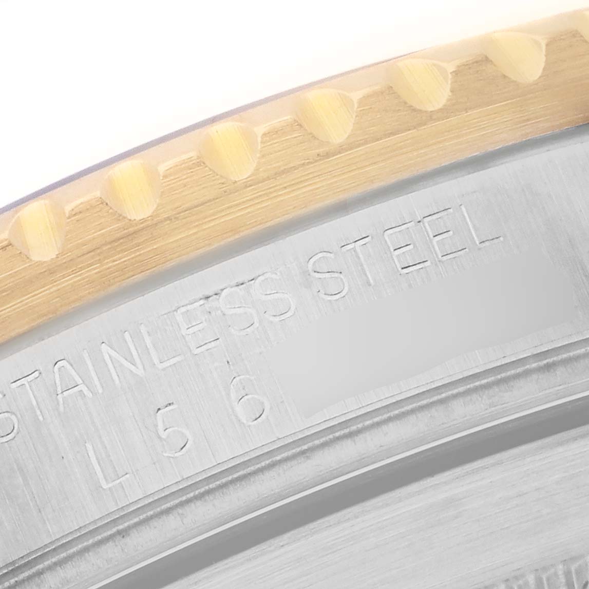 The image shows a close-up of the Rolex Submariner 16613 Men
s Steel and Gold (two tone) Black Dial 16613 Men
s Steel and Gold (two tone) Black Dial bezel and case, highlighting the stainless steel engraving.