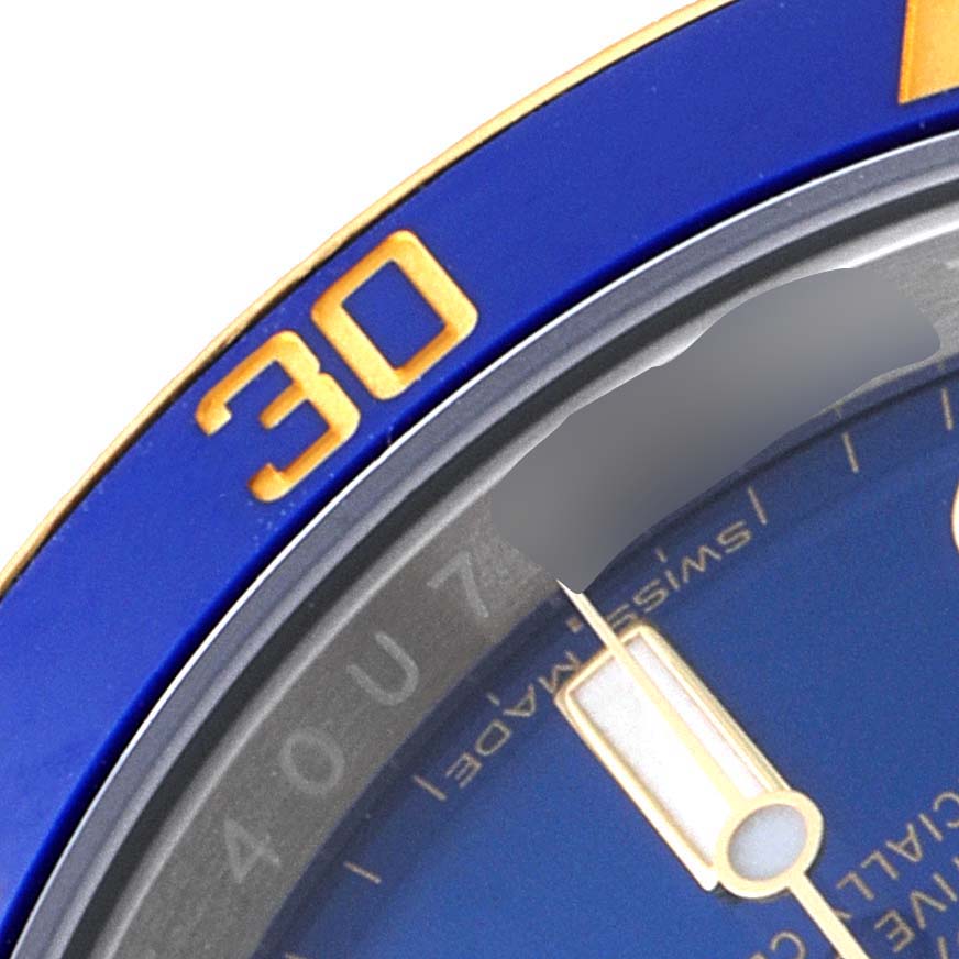 This close-up angle shows a part of the blue bezel, the minute hand, and partial dial of the Rolex Submariner 116613 Men's Steel and Gold (two tone) Blue Dial 116613 Men's Steel and Gold (two tone) Blue Dial watch.