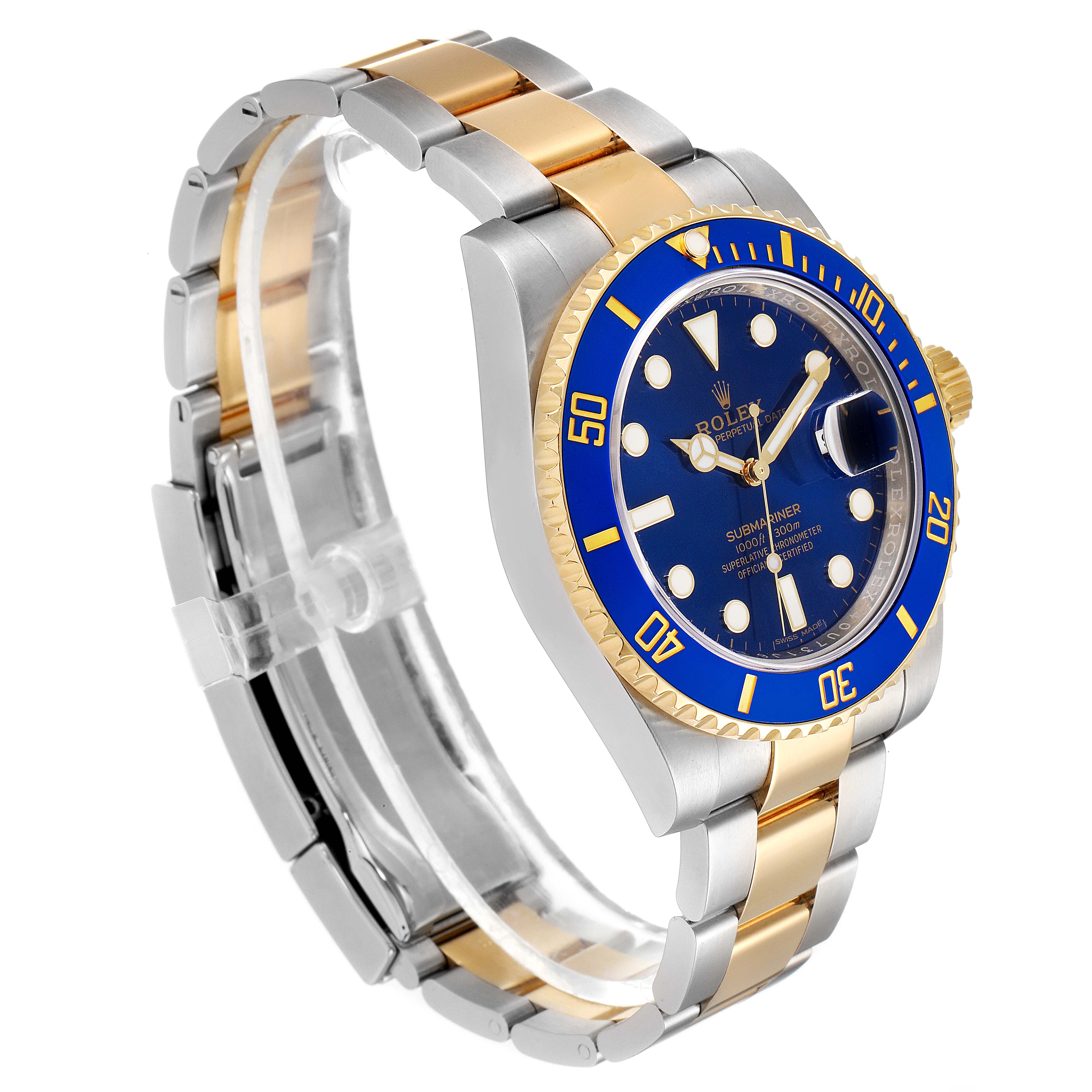 The image shows a Rolex Submariner 116613 Men's Steel and Gold (two tone) Blue Dial 116613 Men's Steel and Gold (two tone) Blue Dial watch from an angled view, highlighting its blue dial, blue bezel, and two-tone metal bracelet.