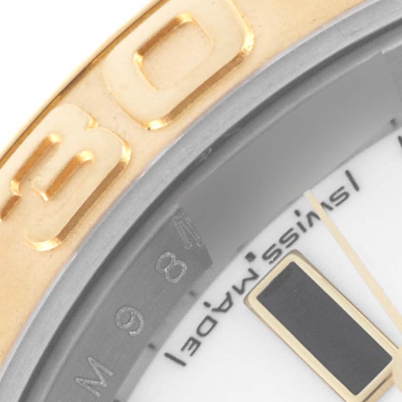 The image shows a close-up of the Rolex Yacht-Master 16623 Men's Steel and Gold (two tone) White Dial 16623 Men's Steel and Gold (two tone) White Dial's bezel, dial edge, and part of a marker.