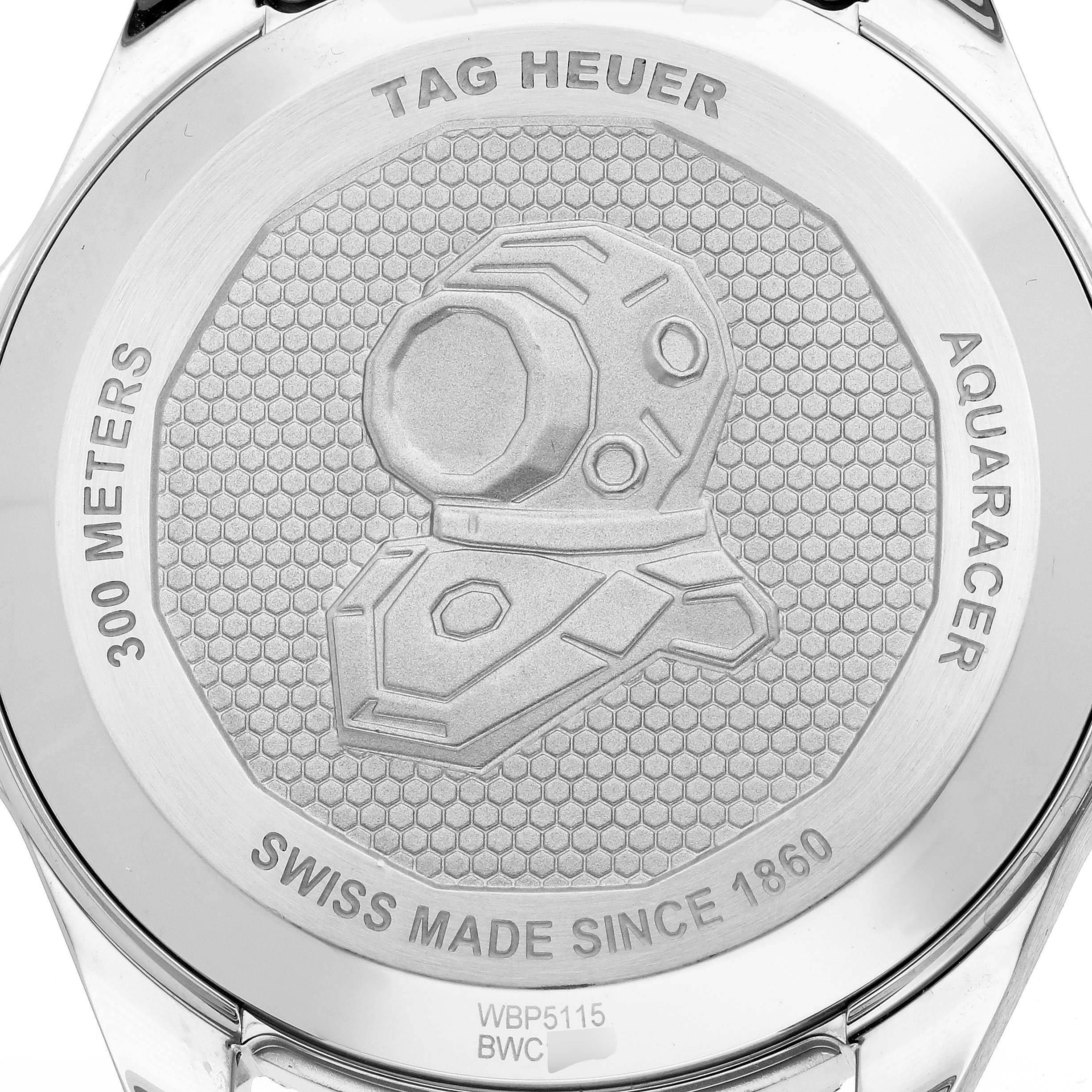 The image shows the back case of a Tag Heuer Aquaracer WBP5115 Men's Stainless Steel Green Dial, featuring engraved text and a diving helmet design.
