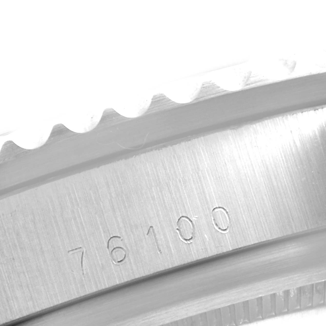 The image shows a close-up angle of the Tudor Submariner 79090 Men
s Stainless Steel Black Dial 79090 Men
s Stainless Steel Black Dial
s brushed stainless steel case with the model number 76100 engraved.