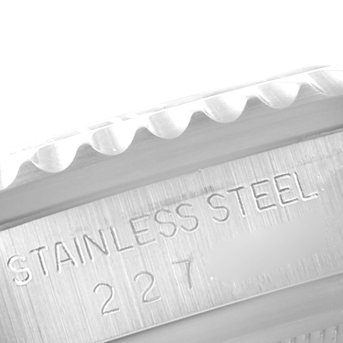 The image shows a close-up of the casing and bezel with the engraving "STAINLESS STEEL" on a Tudor Submariner 79090 Men
s Stainless Steel Black Dial 79090 Men
s Stainless Steel Black Dial watch.