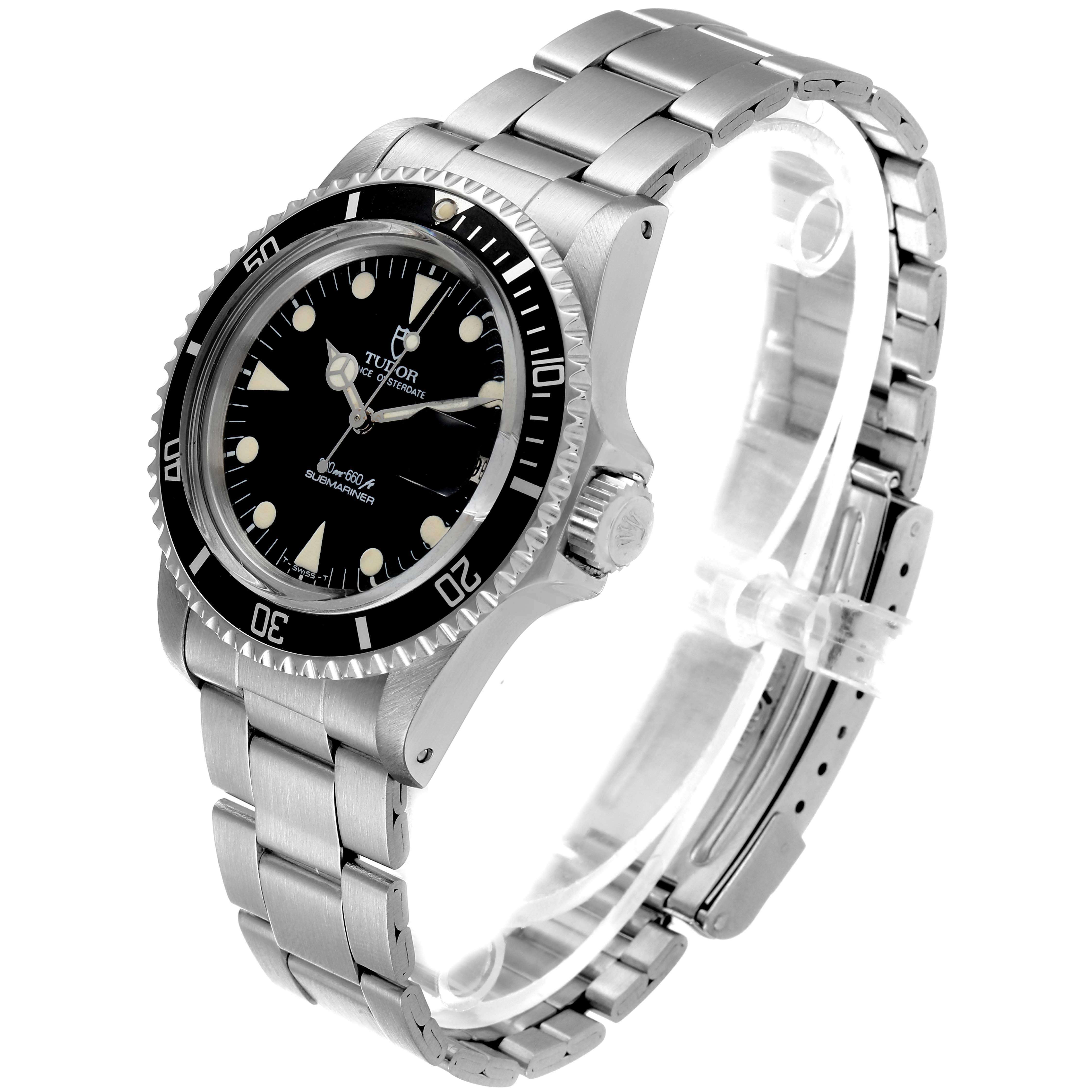 The Tudor Submariner 79090 Men
s Stainless Steel Black Dial 79090 Men
s Stainless Steel Black Dial watch is shown at a tilted angle, revealing its face, bezel, crown, and stainless steel bracelet.