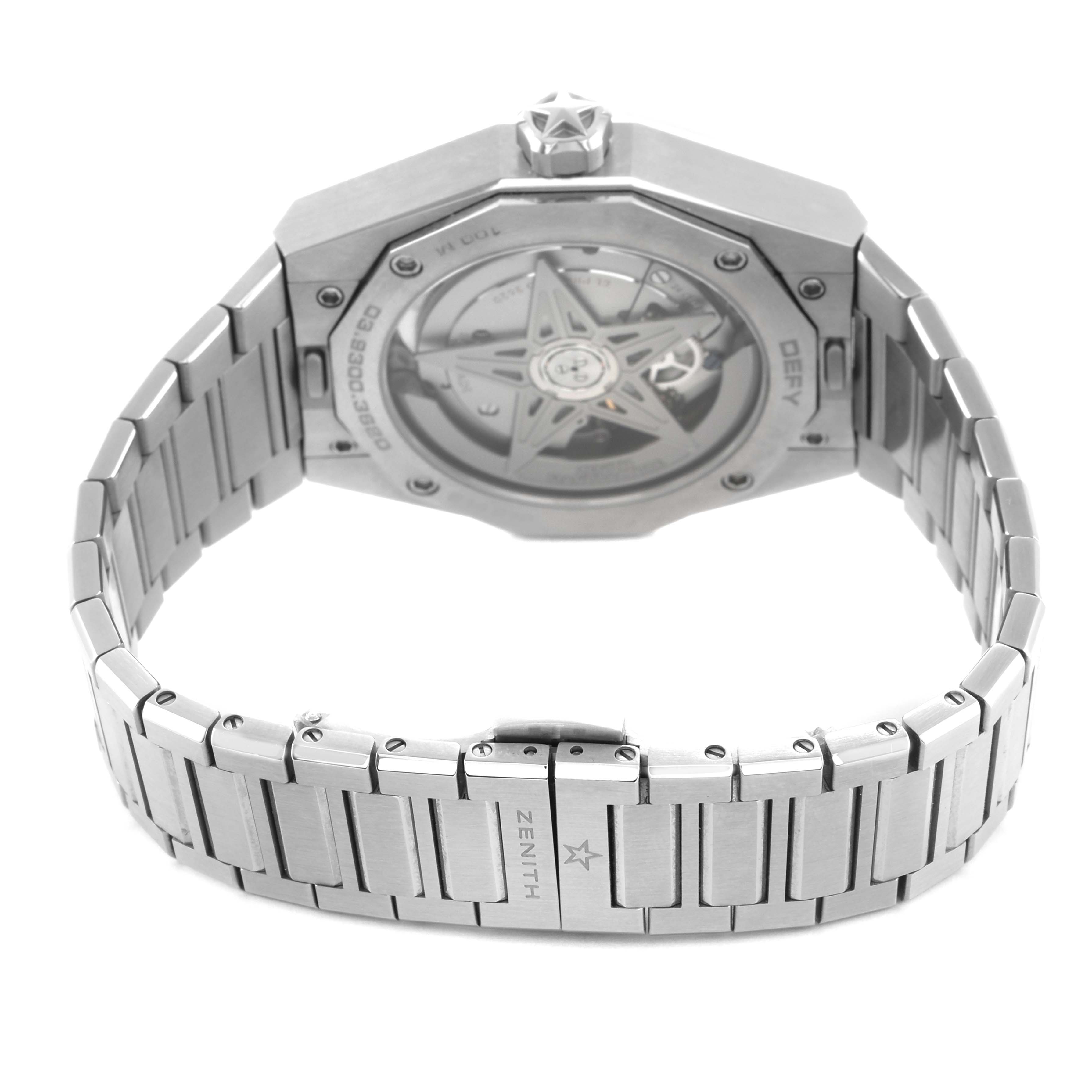 The image shows the back view of a Zenith Defy 03.9300.3620 Men's Stainless Steel Black Dial watch, highlighting the case back and metal bracelet.