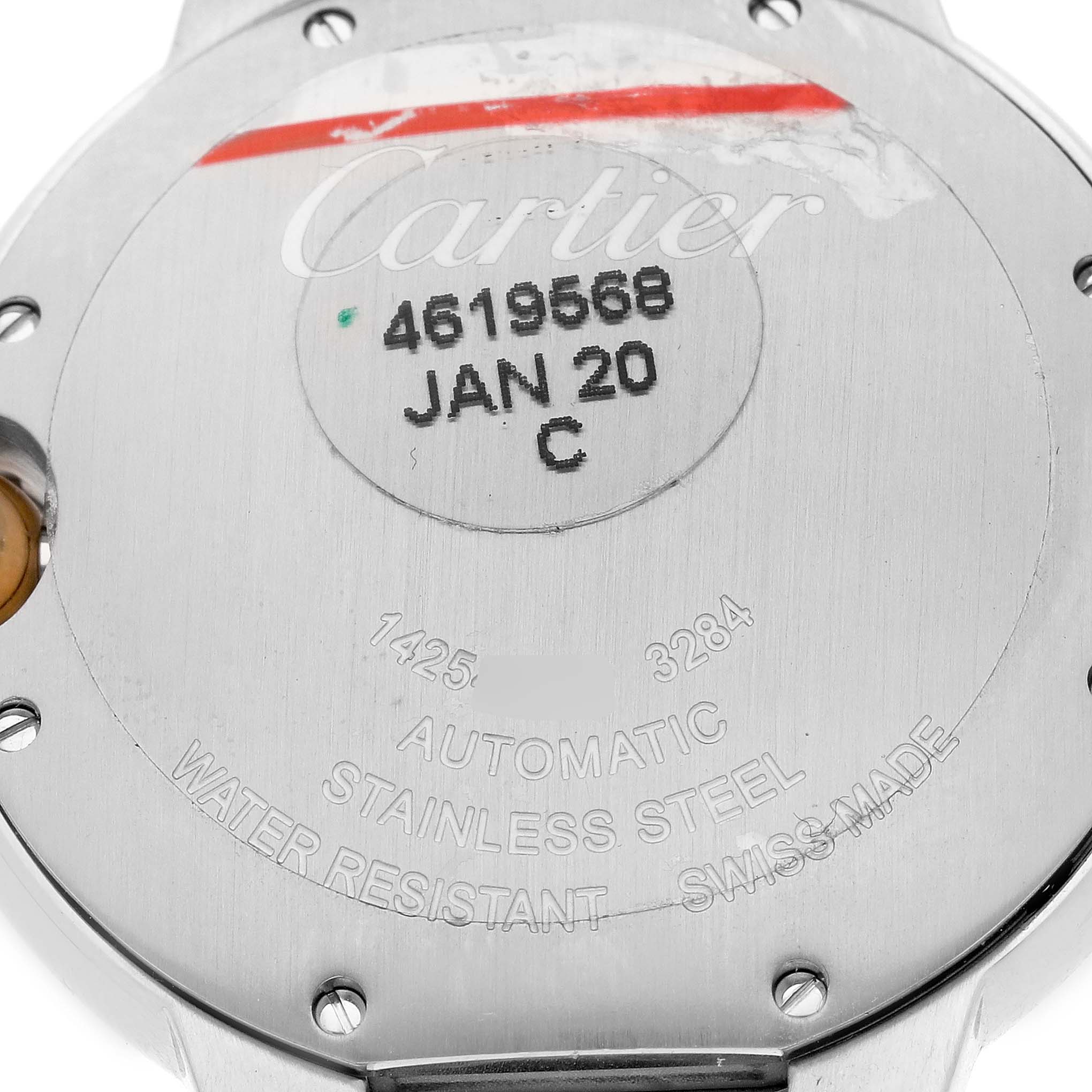 The image shows the case back of a Cartier Ballon Bleu W2BB0012 Women
s Steel and Gold (two tone) Silver Dial W2BB0012 Women
s Steel and Gold (two tone) Silver Dial watch, displaying engravings and a serial number.